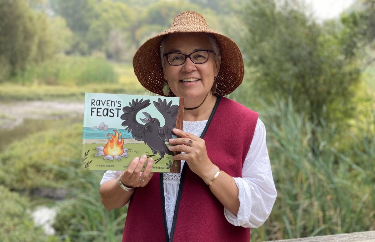 A picture of Kung Jadee holding her book Raven's Feast