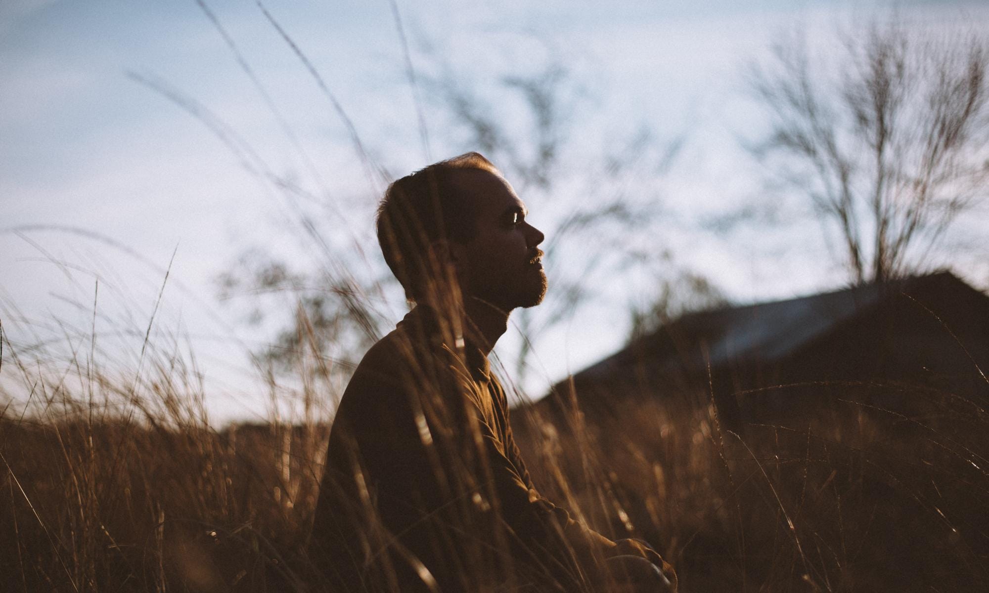 Someone meditating outdoors to reflect the importance of managing stress and anxiety.