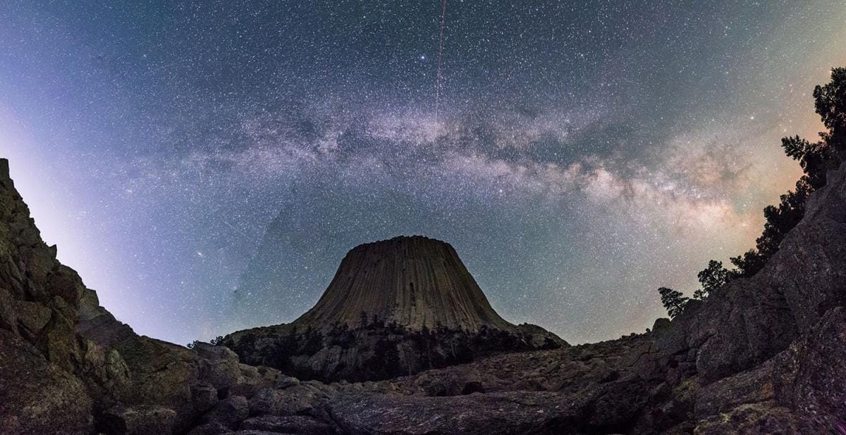 Stunning Milky Way galaxy backdrop framing Devil's Tower, Wyoming, in a mesmerizing night sky scene.