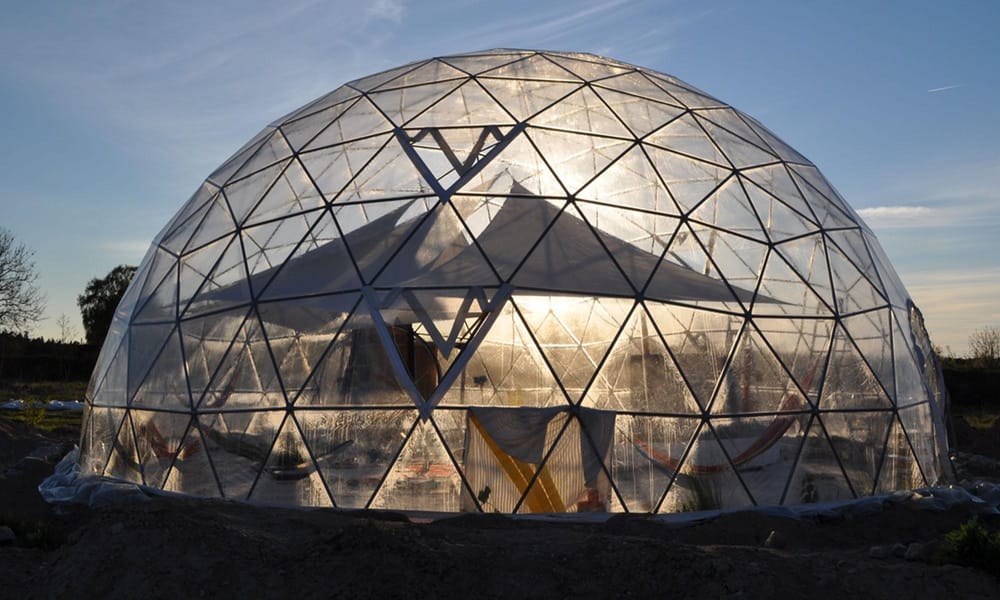 A close-up photo of a geodesic dome at Suderbyn Ecovillage. 