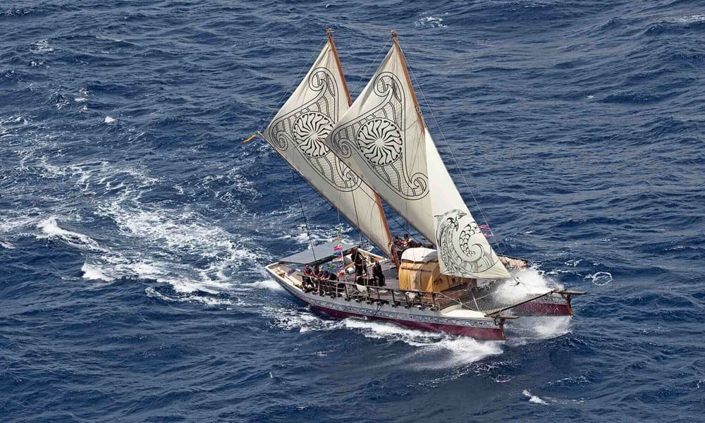 A zoomed out photo of the Hinemoana sailing across the Pacific Ocean. 