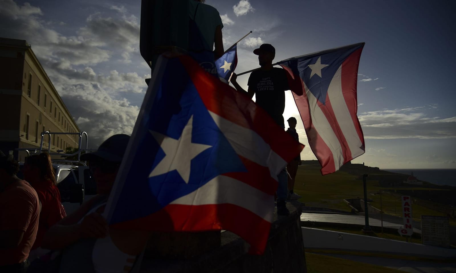 A photo of protestors holding Puerto Rico flags.